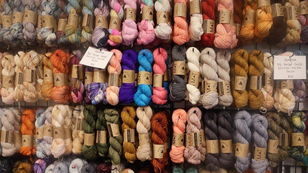 Madeline Tosh brand yarn hangs on the wall in JuJu Knits. The owner, Julie Hatch Fairley, hosts a knitting circle on Wednesdays.