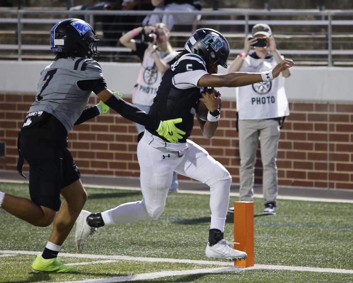 Lake Ridge quarterback DeShawn Edwards (5) scores in front of North Crowley safety Elijajuan Houston (7) during the first half of a UIL football game between North Crowley and Lake Ridge at Vernon Newsom Stadium in Mansfield, Texas, Thursday, October 9, 2025.