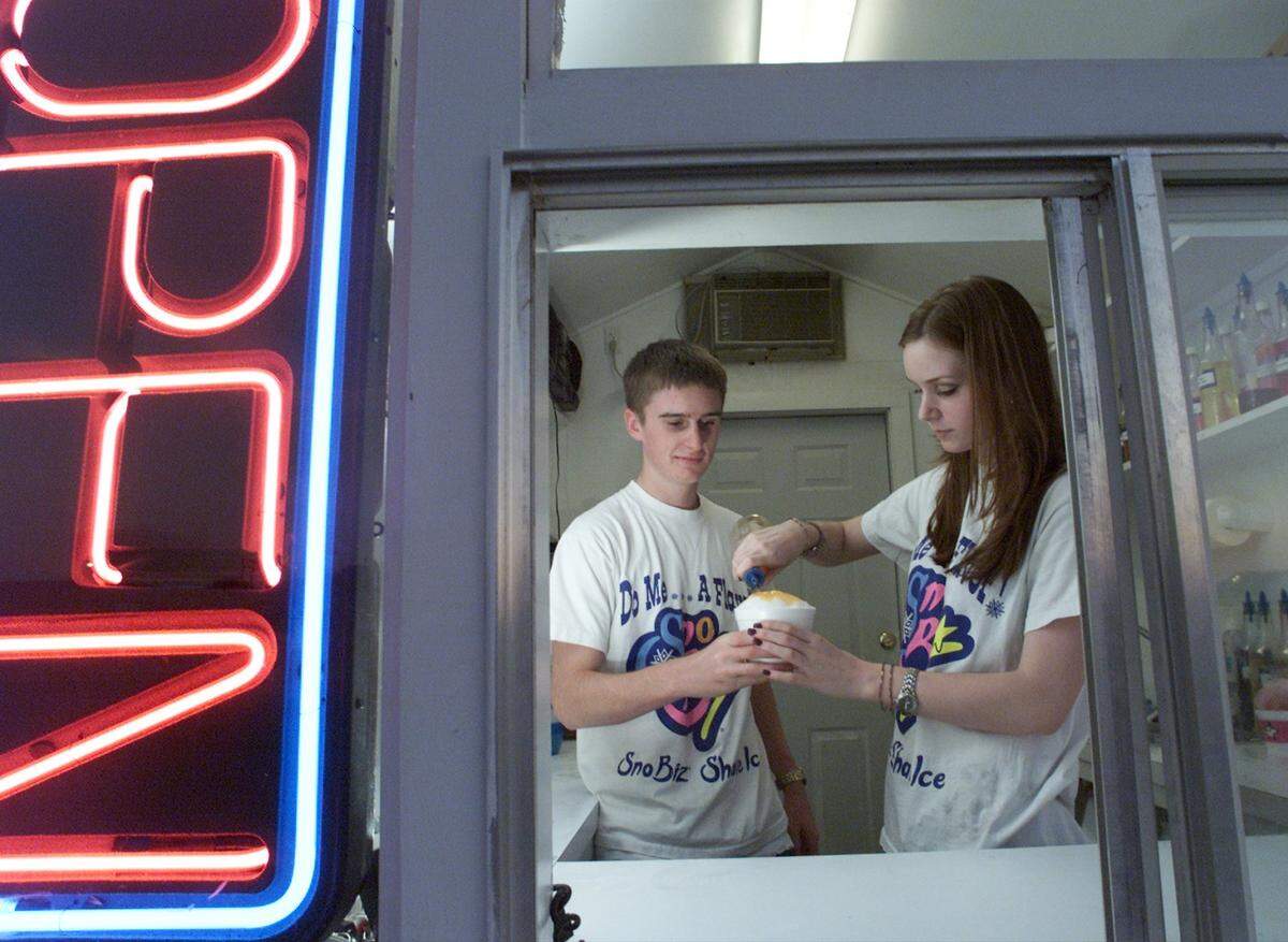 Aug. 28, 2000: Siblings Charles Bell, 15 and Bonnie Bell, 17, make a snow cone at their family owned snow cone stand in Weatherford. The Bell family has owned the stand for 11 years to help put their eight kids through college. Charles and Bonnie are the last two on track to get to college.