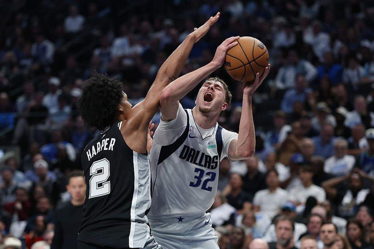 DALLAS, TEXAS - OCTOBER 22: Cooper Flagg #32 of the Dallas Mavericks is fouled by Dylan Harper #2 of the San Antonio Spurs during the second half at American Airlines Center on October 22, 2025 in Dallas, Texas. NOTE TO USER: User expressly acknowledges and agrees that, by downloading and or using this photograph, User is consenting to the terms and conditions of the Getty Images License Agreement. (Photo by Stacy Revere/Getty Images)