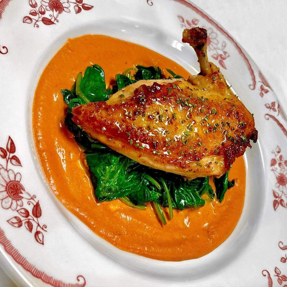 Lavender-glazed chicken with sauteed spinach at Le Margot in Fort Worth.
