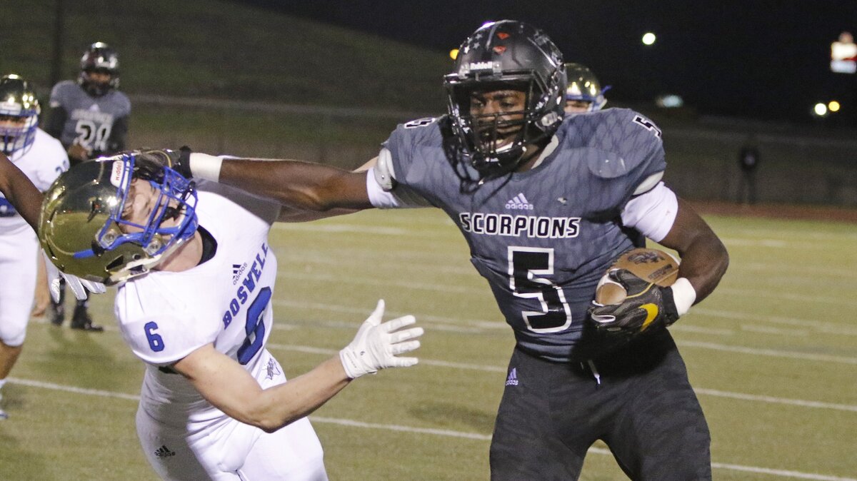 South Hills running back Anthony Watkins (5) stiff arms Boswell wide receiver Jordan Naylor (6) for yardage during the first half of a high school football game at Clark Stadium Thursday, Oct. 25, 2018. South Hills led 13-9 at the half. (Special to the Star-Telegram Bob Booth)