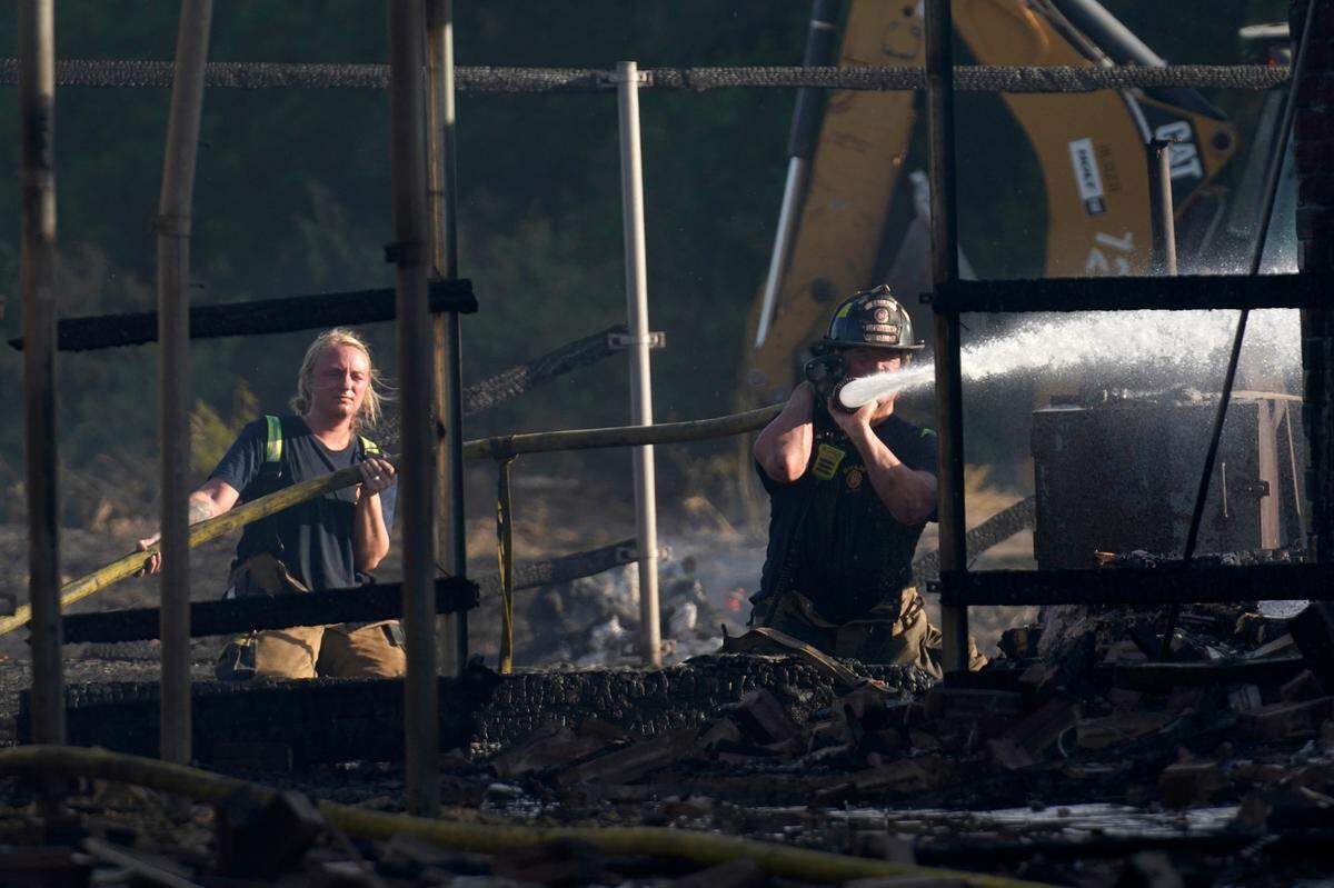 Firefighters put out hot spots on a home that was one of at least 26 that were damaged or destroyed Monday in Balch Springs.