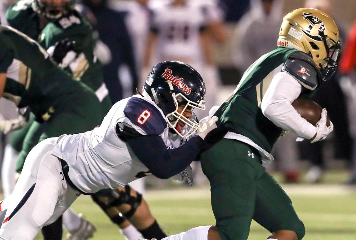 Birdville running back Laderrious Mixon (9) gets dragged down by Denton Ryan defensive tackle Jay Sheppard (8) during the first half, Thursday night, November 7, 2019 played at Birdville Fine Arts/Athletics Complex in North Richland Hills, TX.
