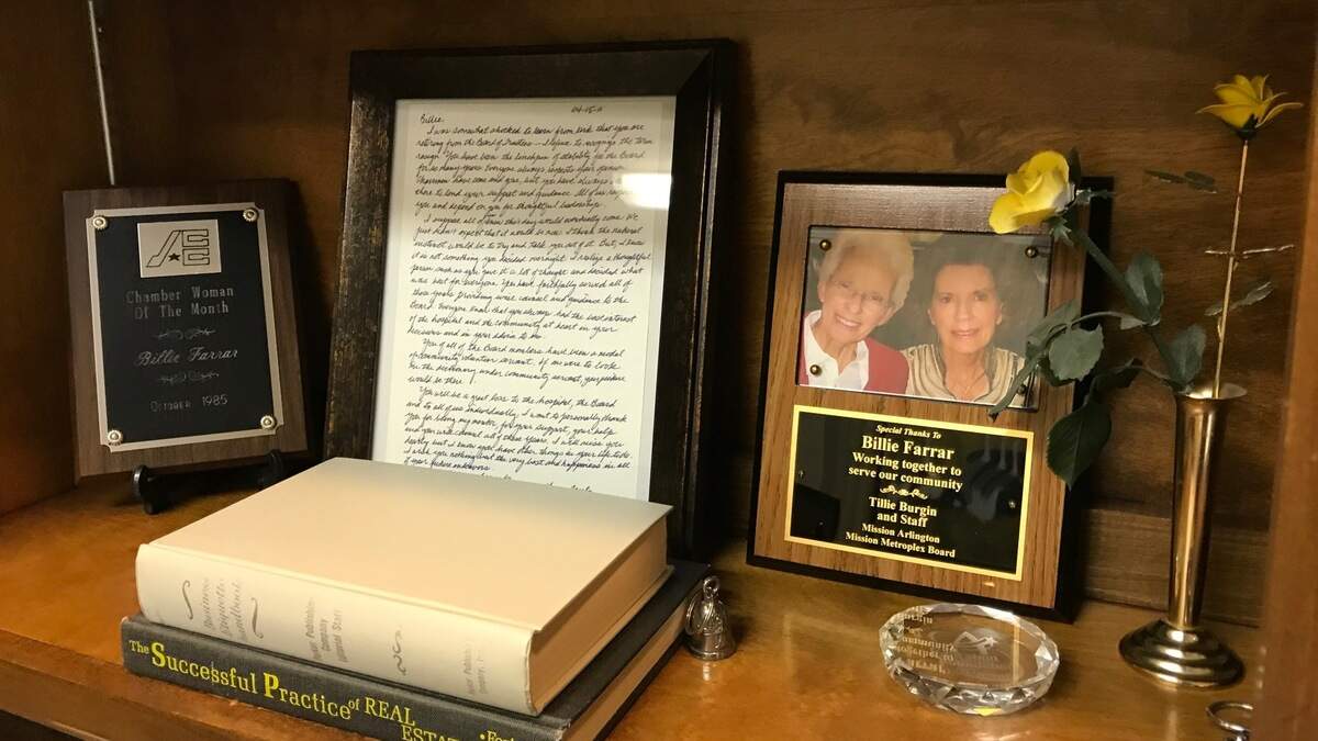 A shelf in the late Billie Farrar’s office features awards and other memorabilia. Farrar died Oct. 17 at 91 after several decades as a real estate agent.