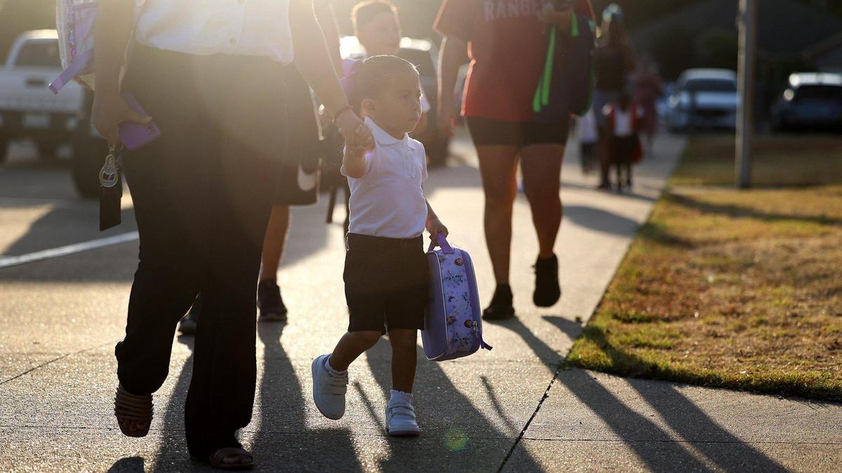 Parents and children arrive at T.A. Sims Elementary School for the first day of school on Aug. 14, 2023. Fort Worth ISD is extending the school day for pre-K students to align with the schedule of other elementary students.