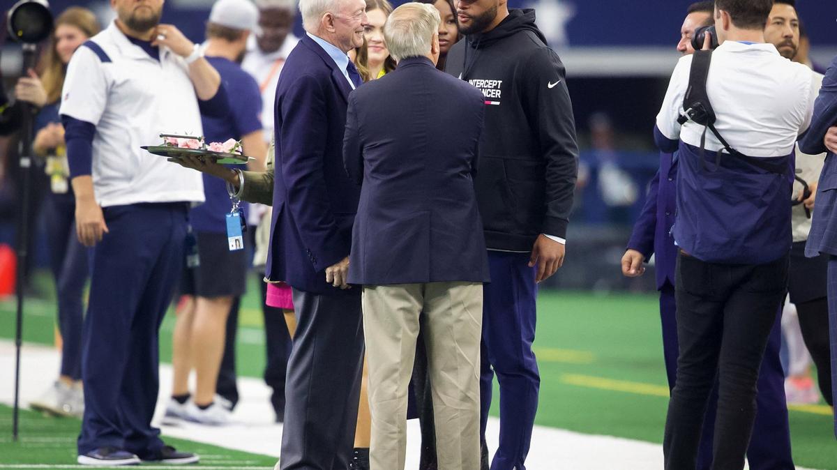 Dallas Cowboys owner Jerry Jones, left, and Dak Prescott, right talk to Sen. Lindsey Graham, R-S.C., on the sidelines before the Cowboys game against the Washington. Jones said there is scenario where Cooper Rush stays at quarterback over healthy Prescott.