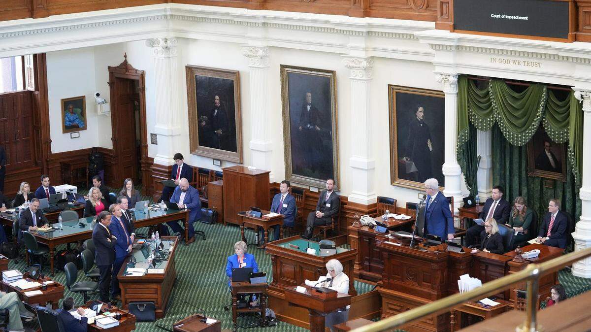 Attorney General Ken Paxton, middle, with his attorneys Tony Buzbee, left, and Dan Cogdell, pleads not guilty at the Capitol on Tuesday September 5, 2023.