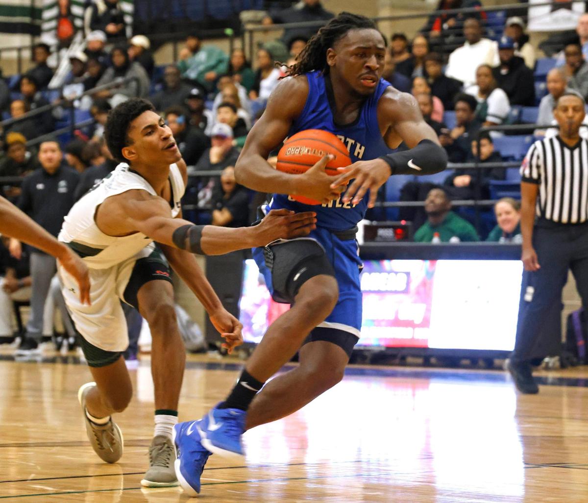Lake Ridge guard Shaqir Pack (0) reaches in on North Crowley wing Chris Shelby (14) during a UIL boys basketball game at Lake Ridge High School in Mansfield, Texas, Friday, Jan. 24, 2025.