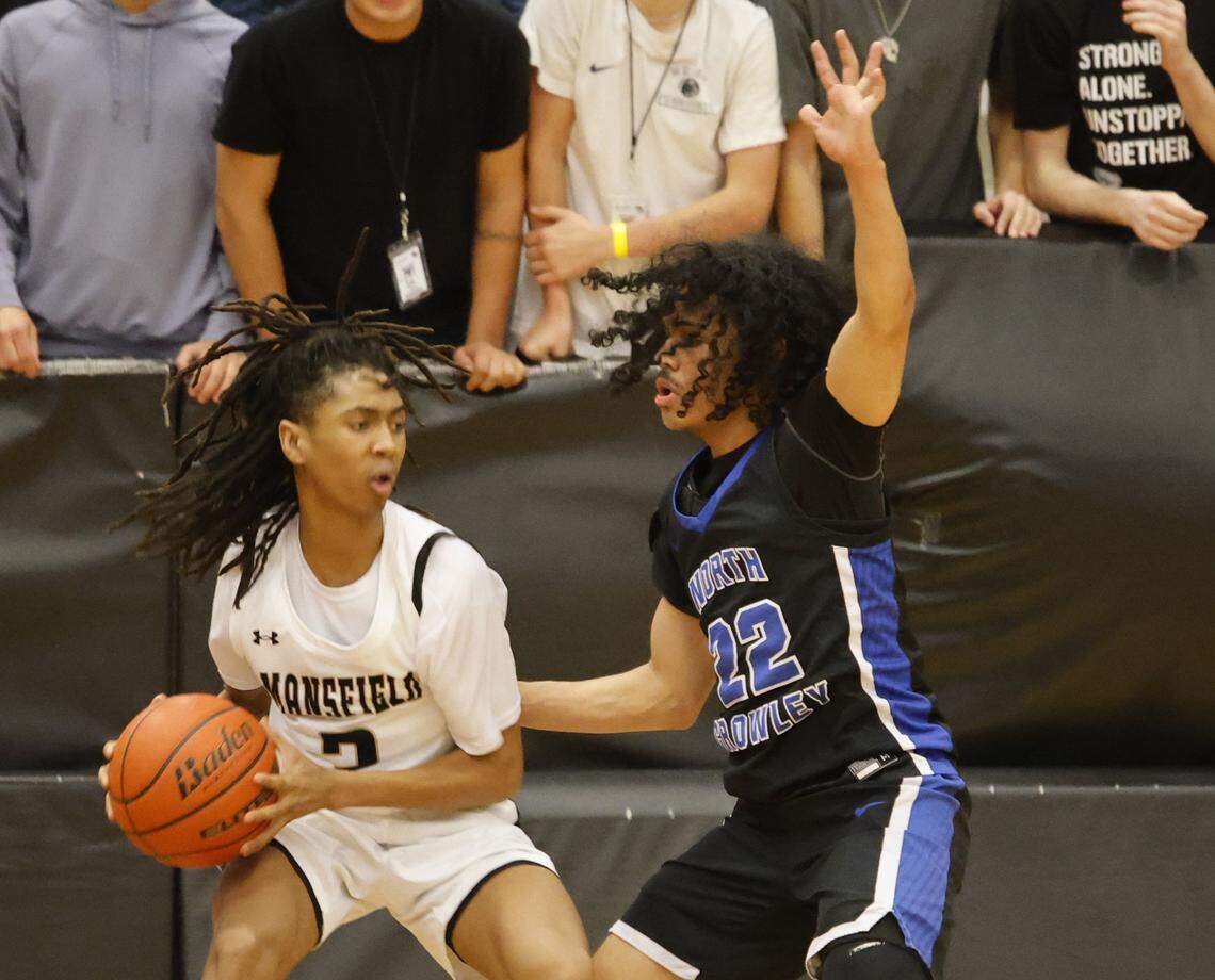 Mansfield's Zion Robinson (2) grabs a rebound in front of North Crowley guard Isaak Hayes (22) during the first half of a UIL boys basketball game between North Crowley and Mansfield at Mansfield High School in Mansfield, Texas, Tuesday Jan. 20, 2026
