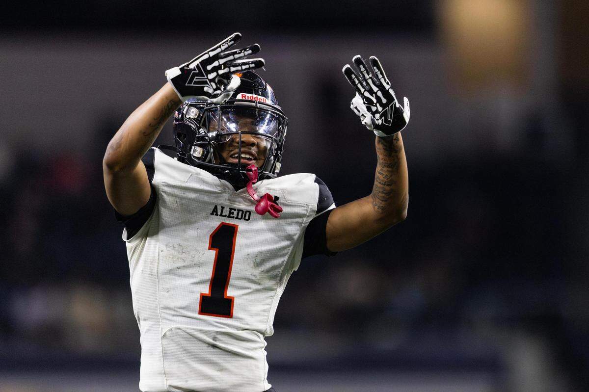Aledo running back Hawk Patrick-Daniels (1) gestures with three fingers to celebrate his third touchdown of the game in the third quarter of the 5A Division I Football State Championship game against the Comal Smithson Valley Rangers at AT&T Stadium in Arlington on Friday, Dec. 15, 2023. Aledo won the programs 12th state title 51-8.