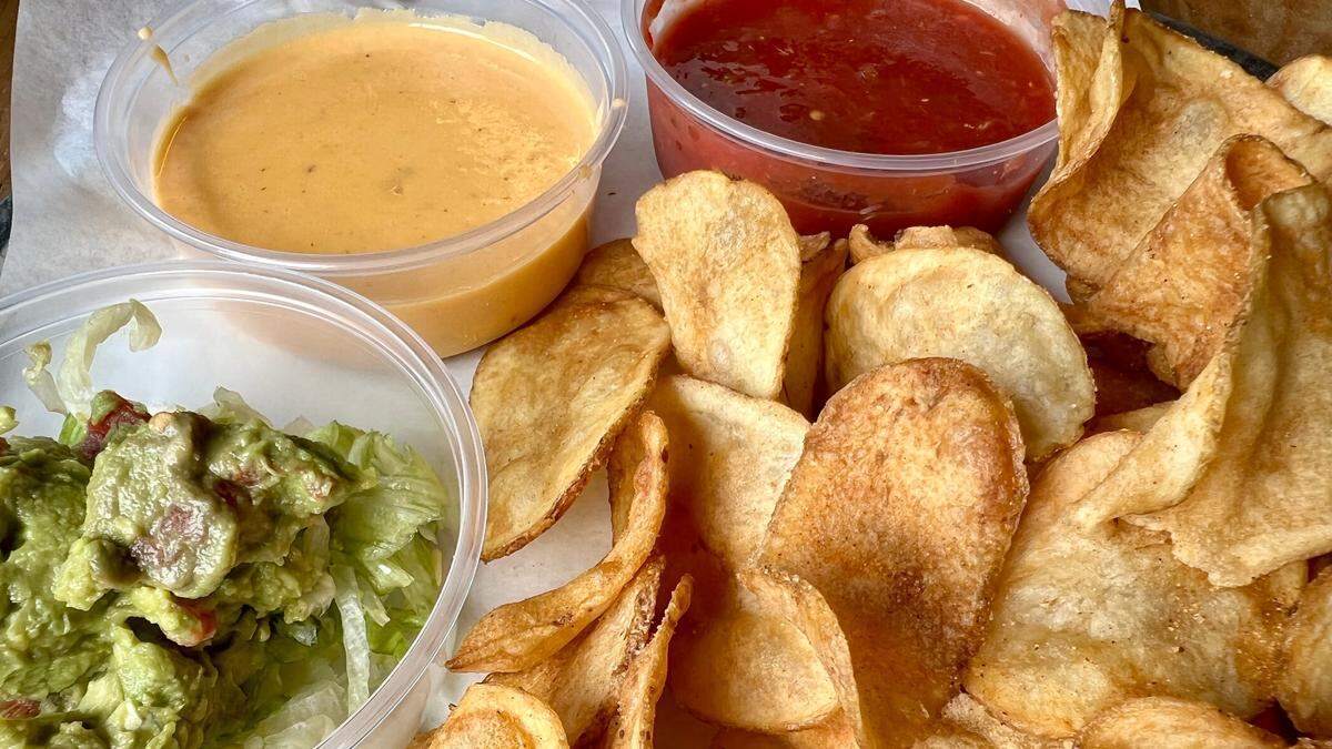 House potato chips, guacamole, queso and salsa at Grumps Burgers.