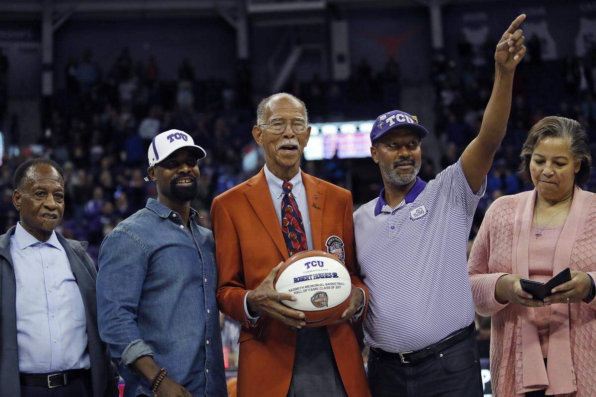 Robert Hughes (center), the winningest boys high school basektball coach in the nation, was honored at the halftime of the Texas Southern versus TCU game in Fort Worth, December 18, 2017.