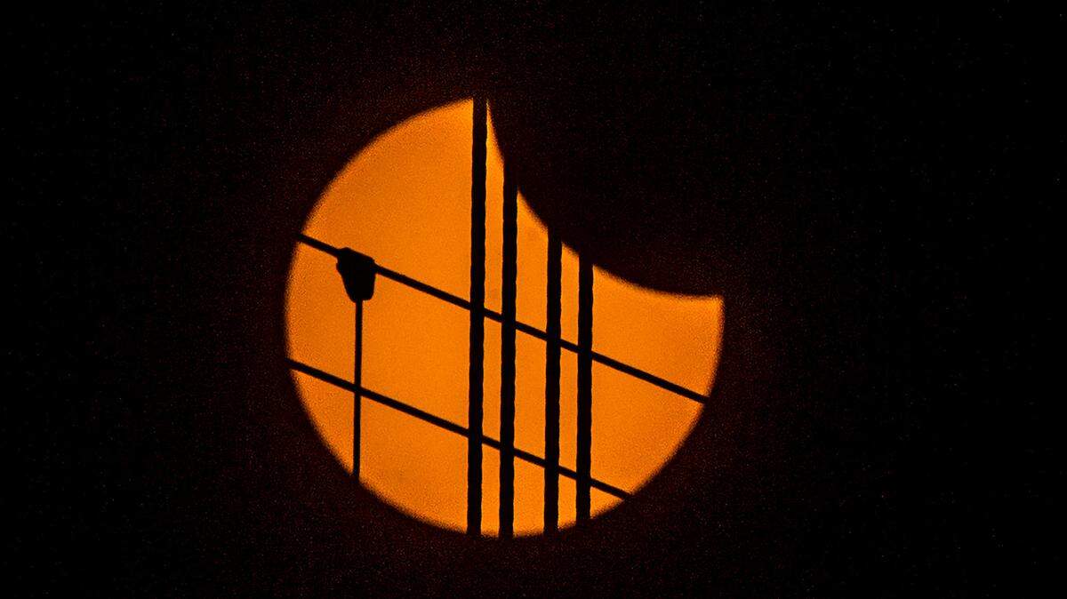 Cables of the Tacoma Narrows Bridge in Gig Harbor, Wash., are silhouetted by the sun as the shadow of the moon begins to move Monday, Aug. 21, 2017. The next total solar eclipse will be visible in Texas April 2024.