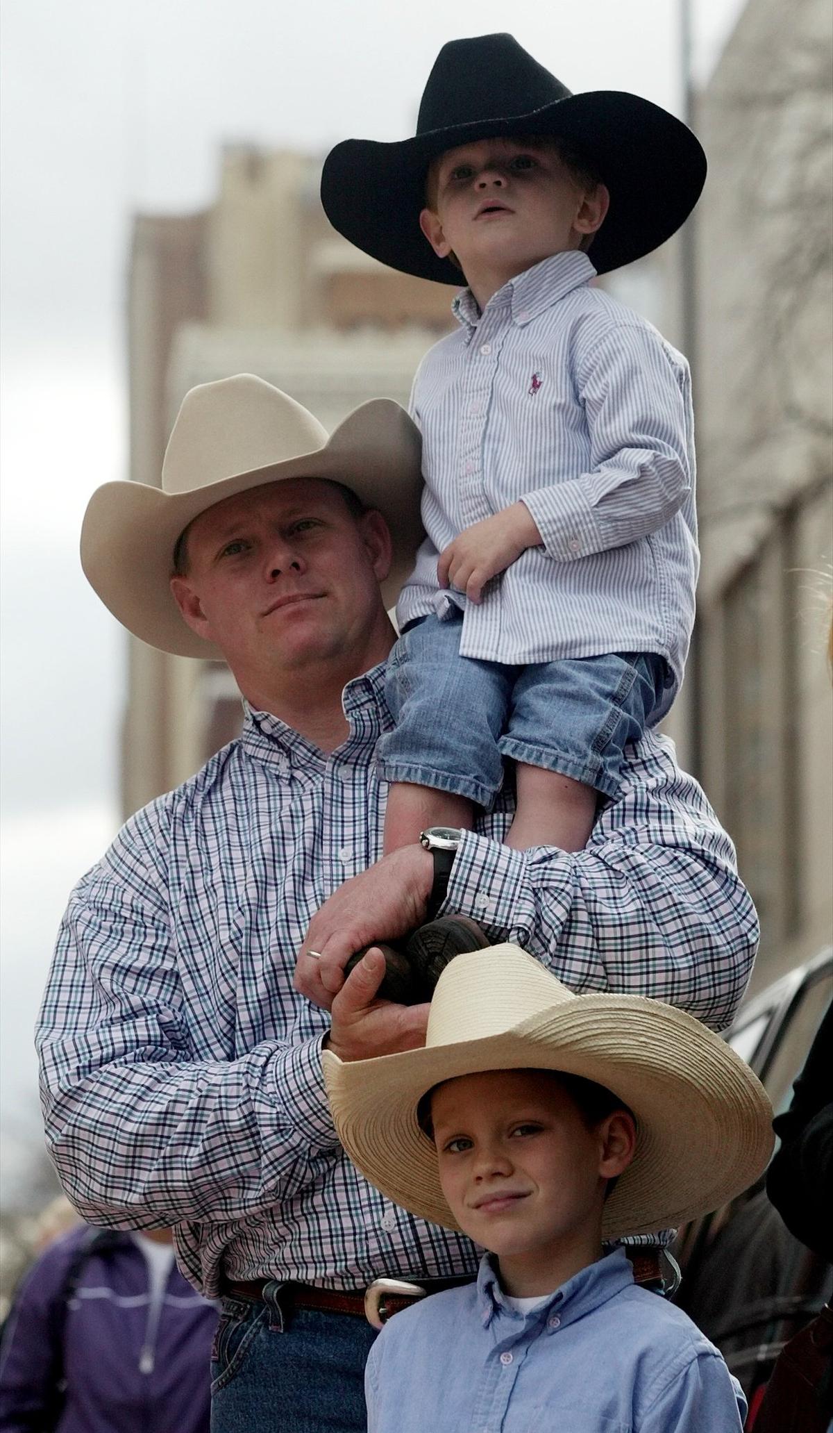 Jan. 17, 2004: Sean Brennan holds his 2-year-old son Parker while his son Ryan, 6, watches during the Fort Wort Stock Show Parade in downtown. The Brennans are from Fort Worth.