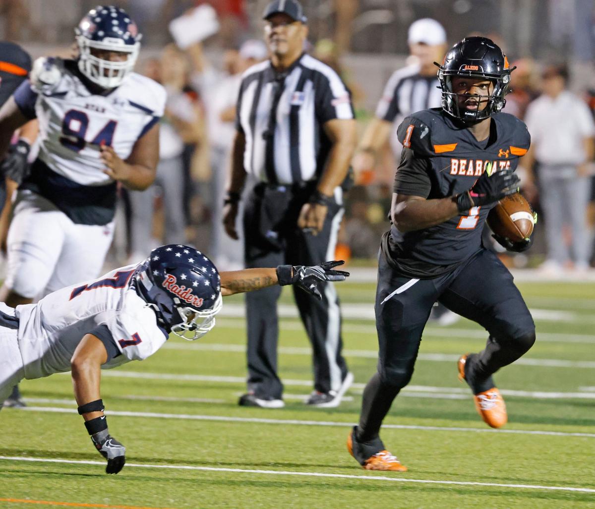 Aledo running back Racine Guillory (1) avoids the reach of Denton Ryan defensive back Jaxson Dozier (7) to gain up the middle during a UIL football game at Buchanan Stadium in Aledo Texas, Friday, Oct. 04, 2024.