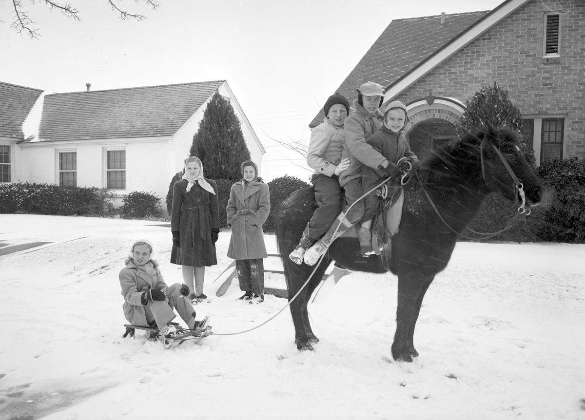 Dec. 31, 1946: “Sitting on the horse are (right to left) Bob Roe Bransom, holding reins, Walter Reeves (center) and Jimmy Canon. On the snow sled is Mary Jo Martin, while Jean Tisdale (left) and Glenda Sproles stand watching.”