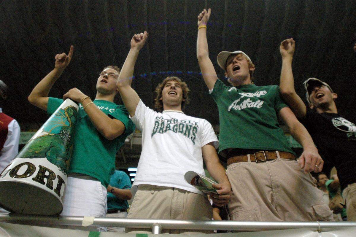 Aug. 28, 2004: Southlake Carroll fans Austin Soldner, left, Derek Rich, Cameron Brown and Kevin Sheehy sing the school song after the Dragons' Texas Football Classic game against Midland Lee in the Alamodome in San Antonio