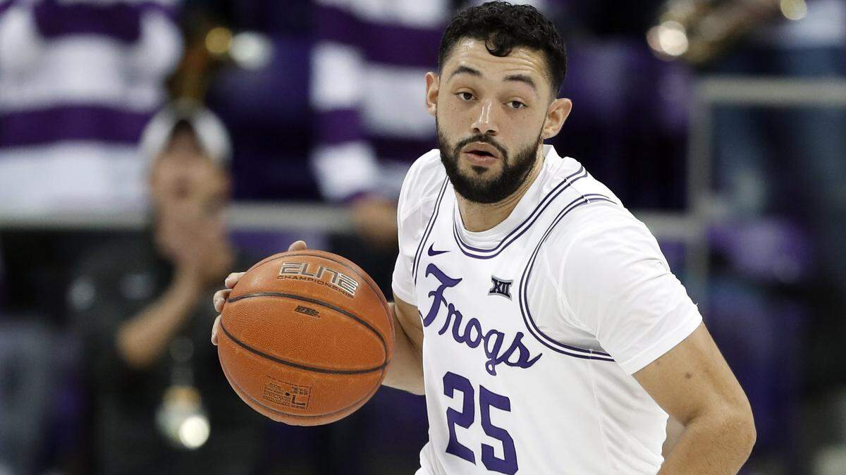 TCU guard Alex Robinson (25) handles the ball during an NCAA college basketball game against Kansas in Fort Worth, Texas, Monday, Feb. 11, 2019. (AP Photo/Tony Gutierrez)