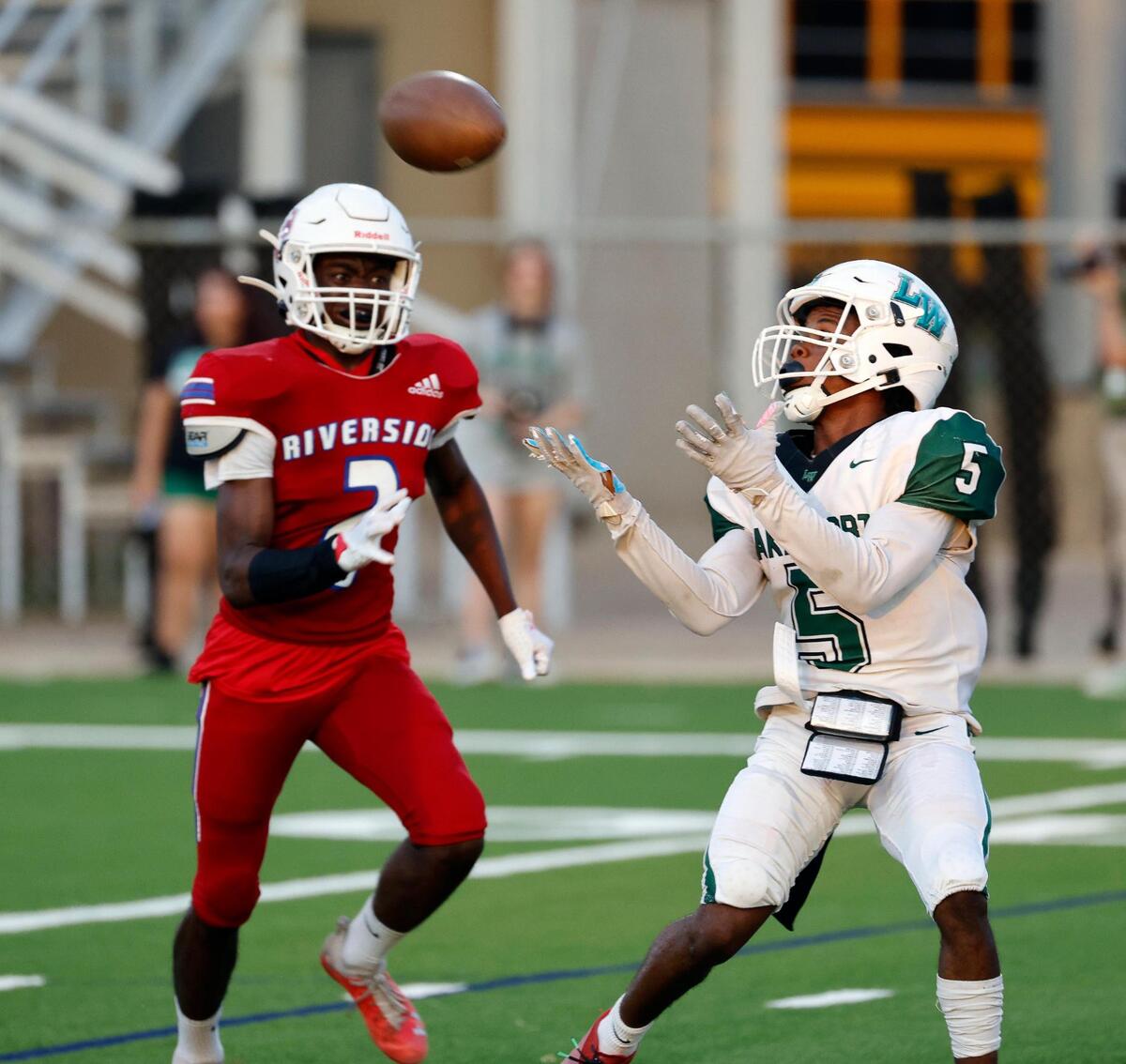 Lake Worth wide receiver Cornell Avington (5) grabs a touchdown pass in front of Carter-Riverside defensive back Davon Carey (2) in the first half of a UIL football game at Scarborough-Handley Field in Fort Worth, Texas, Thursday, Sept. 28, 2023. Lake Worth led Carter-Riverside 44-13 at the half. (Special to the Star-Telegram Bob Booth)