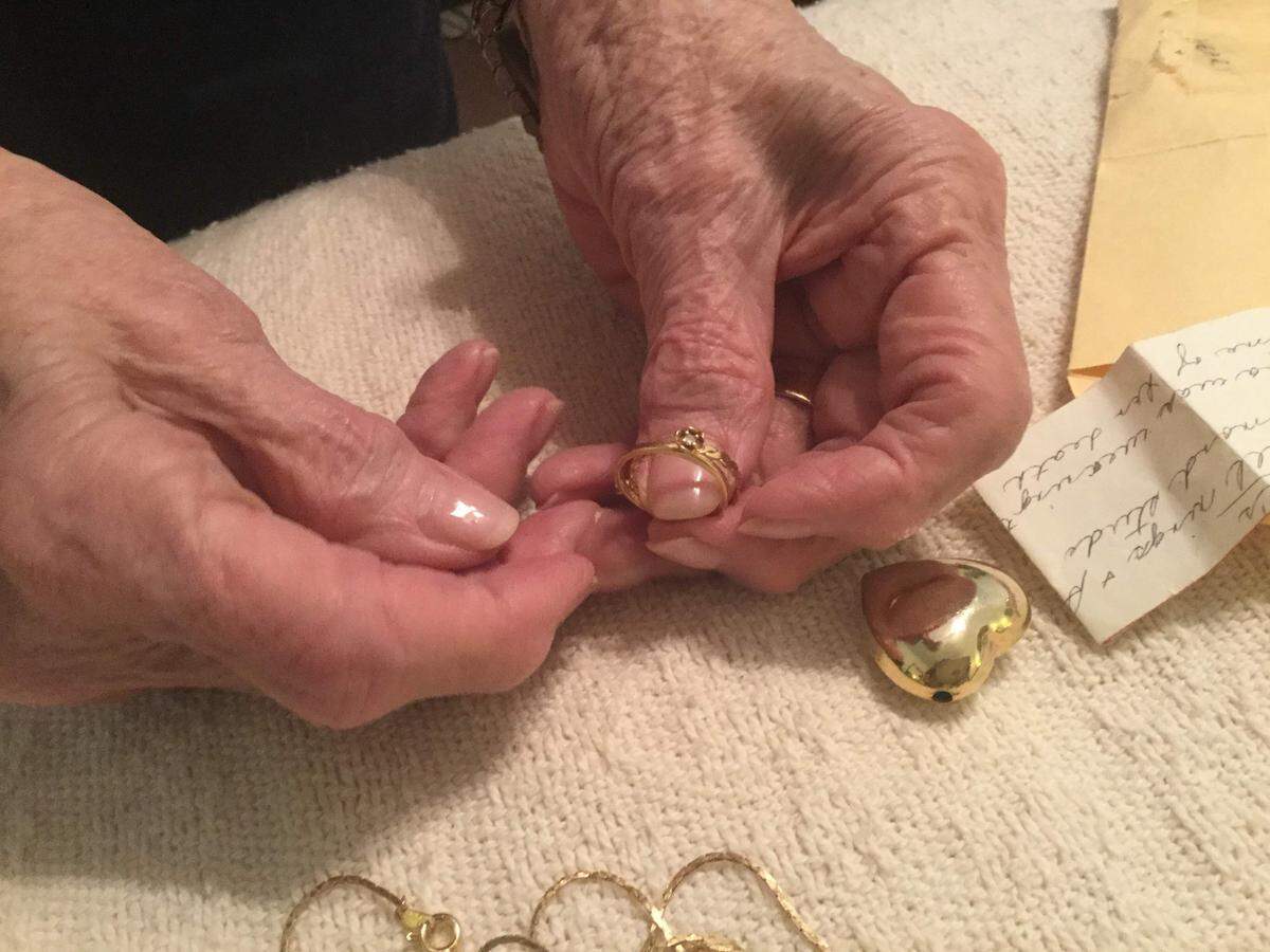Dean McLaughlin looks through jewelry that her daughter had been wearing on the day she was murdered.