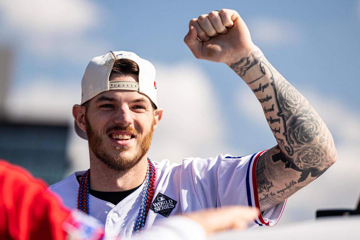 Rangers catcher Jonah Heim celebrates with the crowd for the World Series Parade in front of Globe Life Field in Arlington on Friday, Nov. 3, 2023.