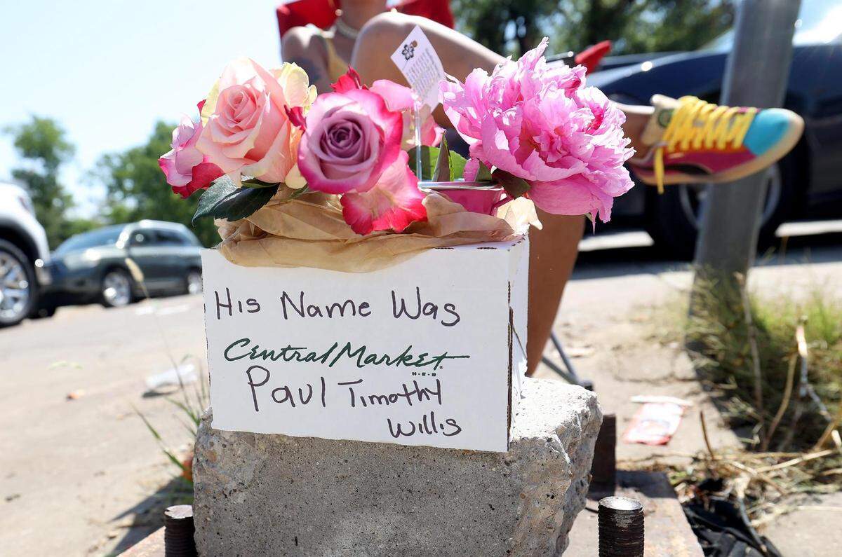 Ka’Desha Weatherly sits in the spot where her son, Paul Timothy Willis, 18, was killed in a shooting during a Fourth of July celebration the previous evening. Weatherly had flowers with her son’s name on them sitting in front of her as the Fourth of July parade traveled down Horne Street in the Como neighborhood on Tuesday, July 4, 2023.