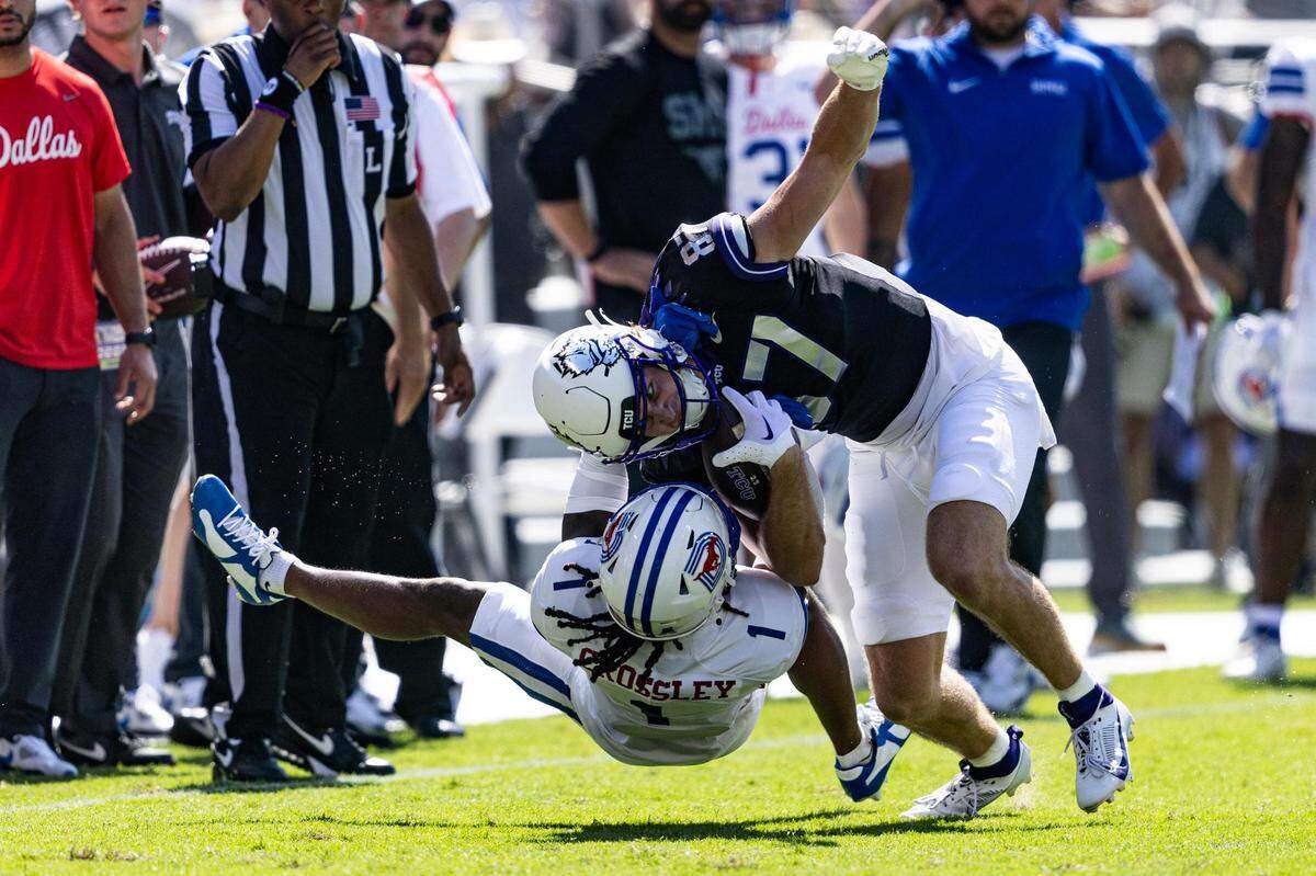 TCU wide receiver Blake Lowell (87) is tackled by SMU defender Brandon Crossley (1) in the first half of a college football game between the TCU Horned Frogs and the SMU Mustangs at Amon G. Carter Stadium in Fort Worth on Saturday, Sept. 23, 2023.