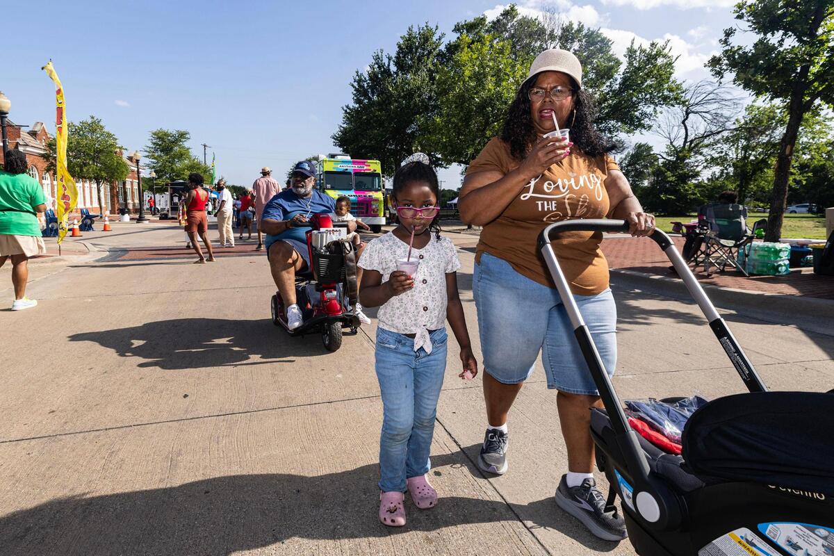 Dione Sims, the granddaughter of Opal Lee, walks with her granddaughter Zoe Rowland, 6, and her husband Robert Sims while he’s carrying their grandson Robert Rowland III during the Freedom Vibes Juneteenth Block Party in Fort Worth on Saturday, June 21, 2025.