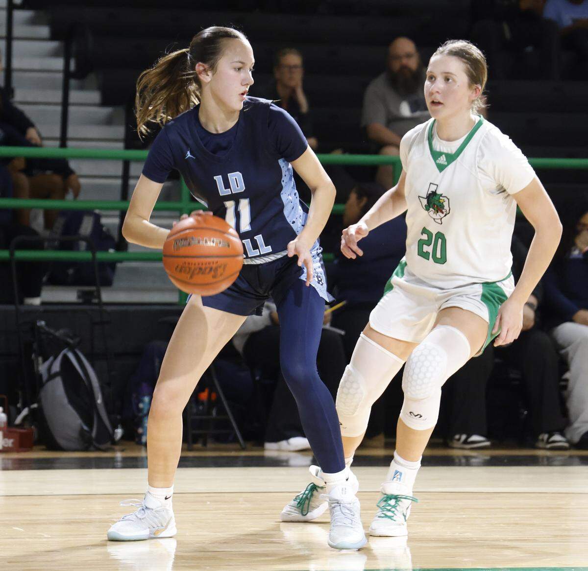 L.D. Bell guard Reagan Bennett (11) looks to get out of the corner against Southlake guard Whitney Jense (20) during the second half of a UIL girls basketball game between L.D. Bell and Southlake Carroll at Southlake Senior High School in Southlake, Texas, Tuesday Feb. 03, 2026