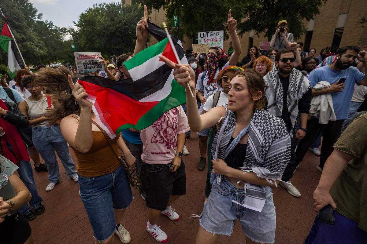 Lisa Valenzuela, a sophomore at University of North Texas, dances to the chants in support of Palestine for the Campus Wide Walkout for Gaza at the campus Library mall on Tuesday, April 30, 2024.