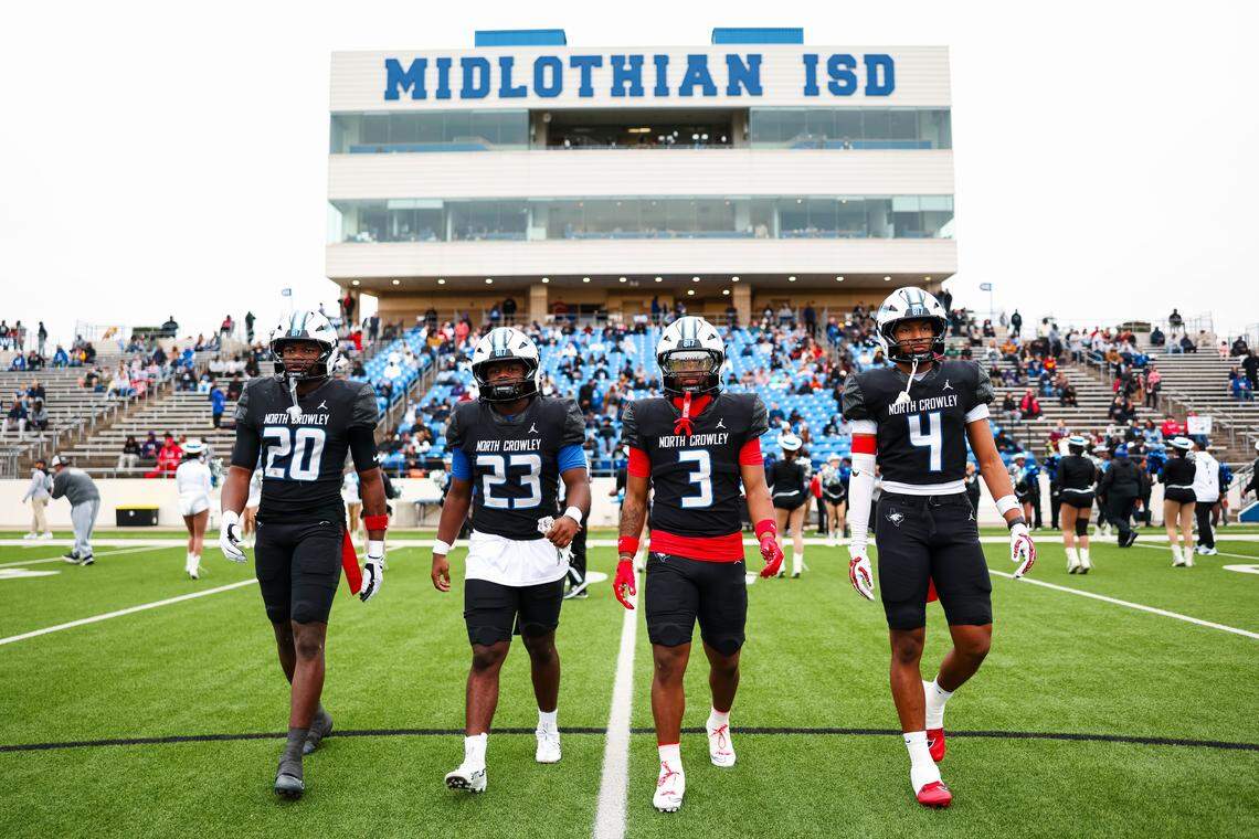 North Crowley’s captains walk toward midfield for the coin toss before a Class 6A Division I regional playoff against Coppell on Saturday at Midlothian ISD Stadium in Midlothian.