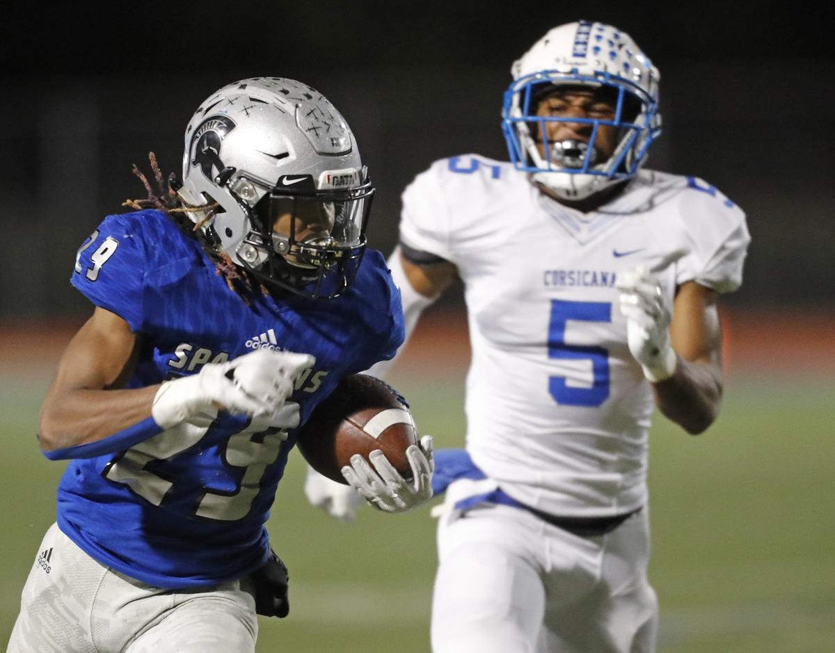 Burleson Centennial running back Chris Mosley (29) outruns Corsicana strong safety Darious Coleman (5) to the end zone in the second half of Friday’s playoff game in Burleson. Centennial defeated Corsicana 28-20.