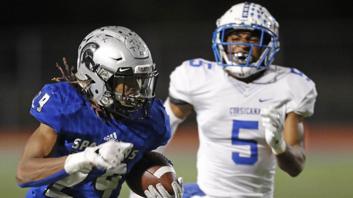 Burleson Centennial running back Chris Mosley (29) outruns Corsicana strong safety Darious Coleman (5) to the end zone in the second half of Friday’s playoff game in Burleson. Centennial defeated Corsicana 28-20.