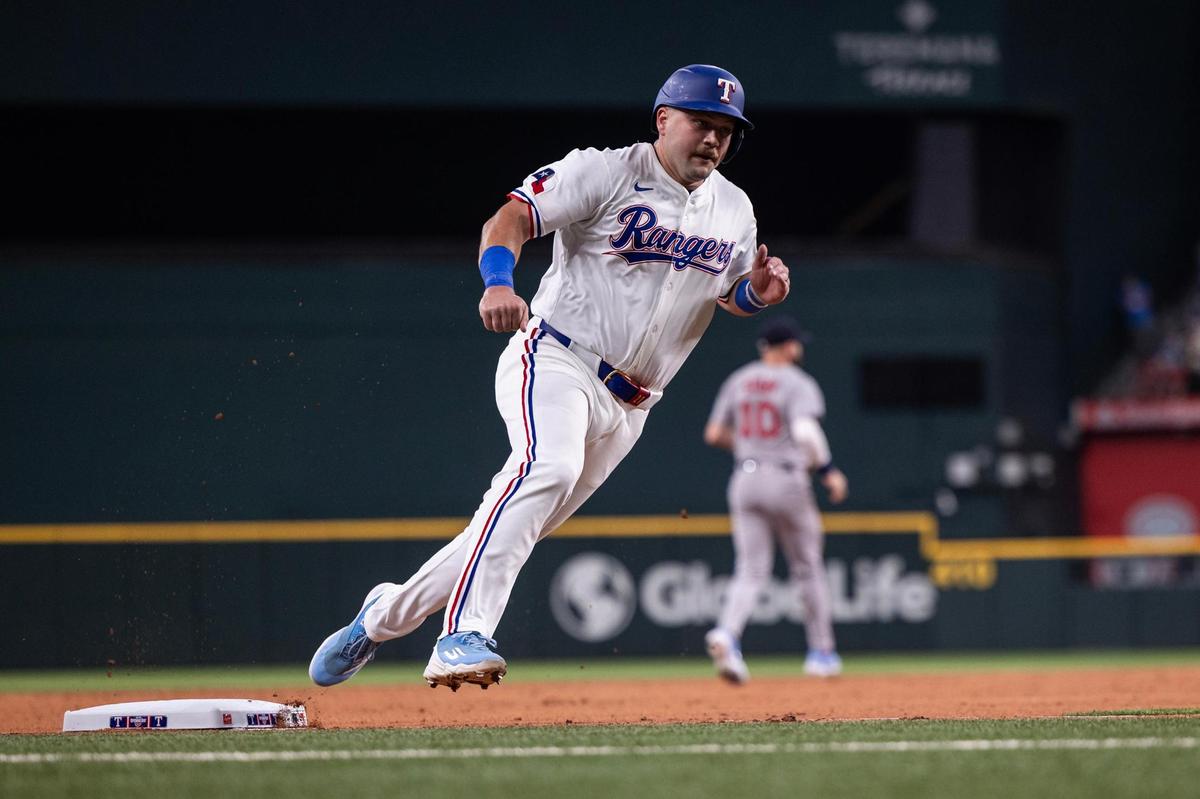 Rangers first baseman Jake Burger (21) rounds third base to score a run in the second inning of the MLB Opening Day game between the Rangers and Red Sox at Globe Life Field in Arlington on Thursday, March 27, 2025.
