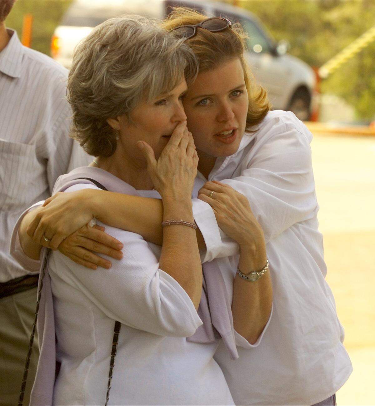 Carol Harris is comforted by her daughter, Alison Harris, as they wait to donate blood at Reunion Arena in Dallas on Sept. 11, 2001. They had friends who lived in New York.
