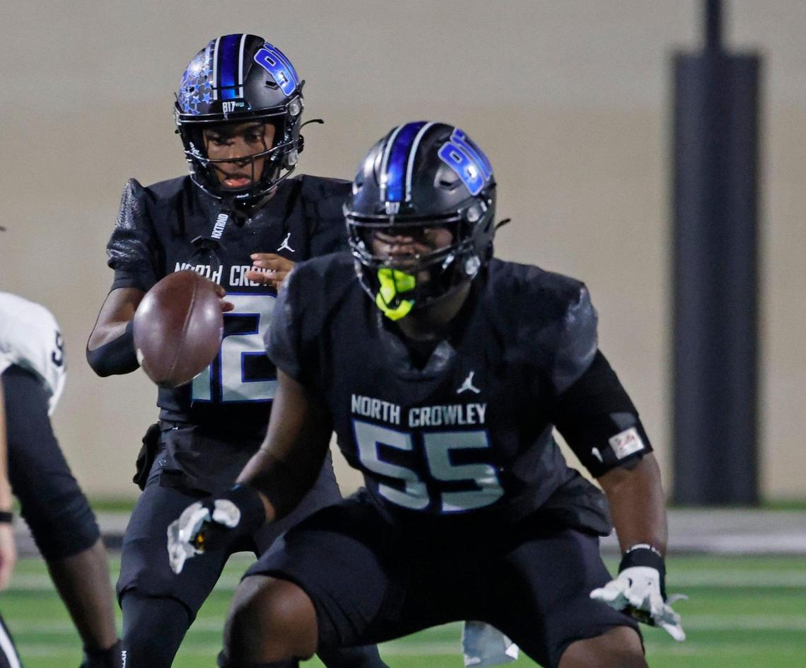 North Crowley quarterback Chris Jimerson (12) takes the snap protected by offensive lineman Henry Fenuku (55)during a UIL Class 6A D1 Area Round football playoff football game at Crowley ISD Multi-Purpose Stadium in Fort Worth, Texas, Friday, Nov. 22, 2024.