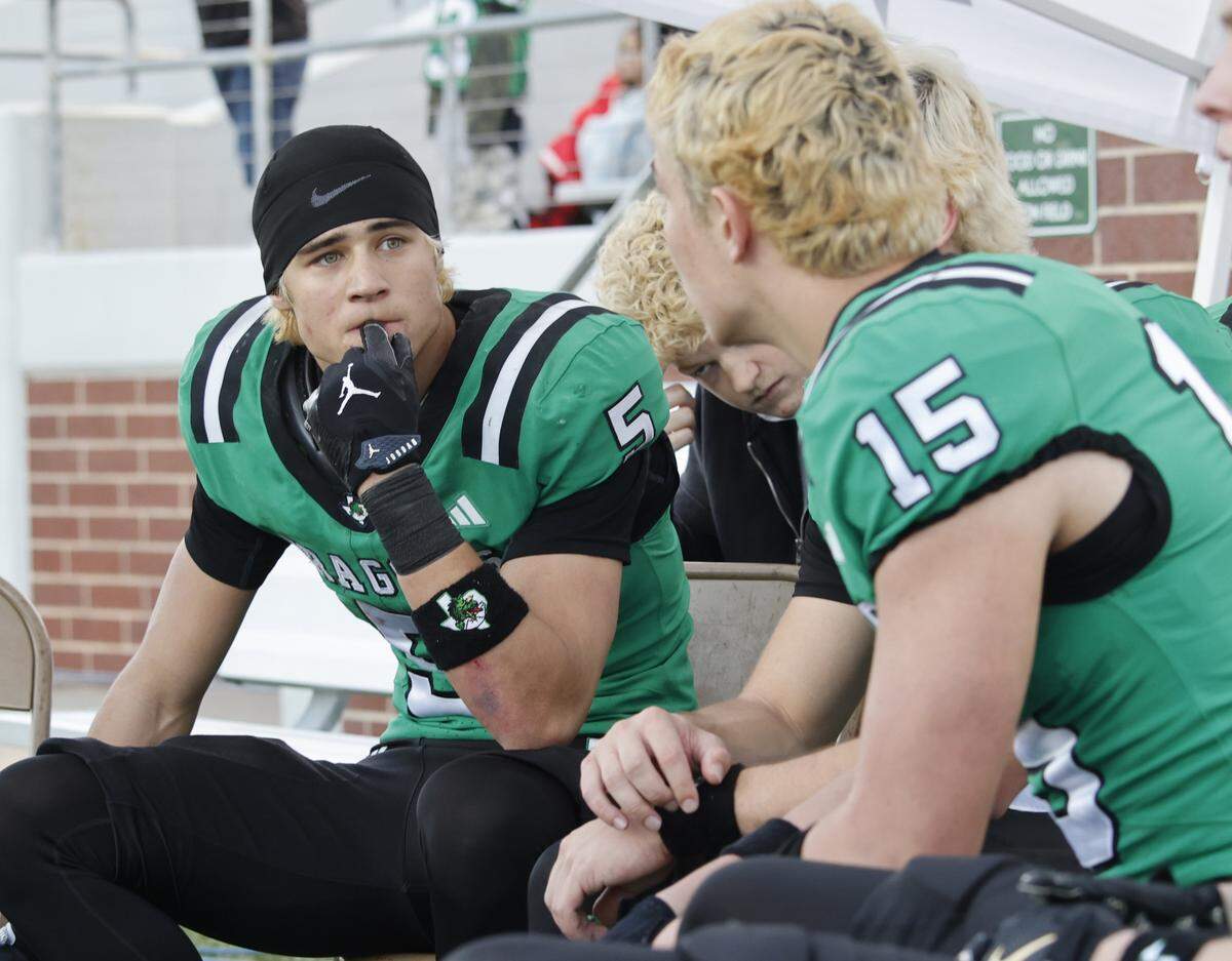 Southlake Carroll wide receiver Blake Gunter (5) talks with wide receiver Caden Mackey (15) during the second half of a UIL Class 6A Division II semifinal against DeSoto on Saturday Dec. 13, 2025 at Vernon Newsom Stadium in Mansfield, Texas.