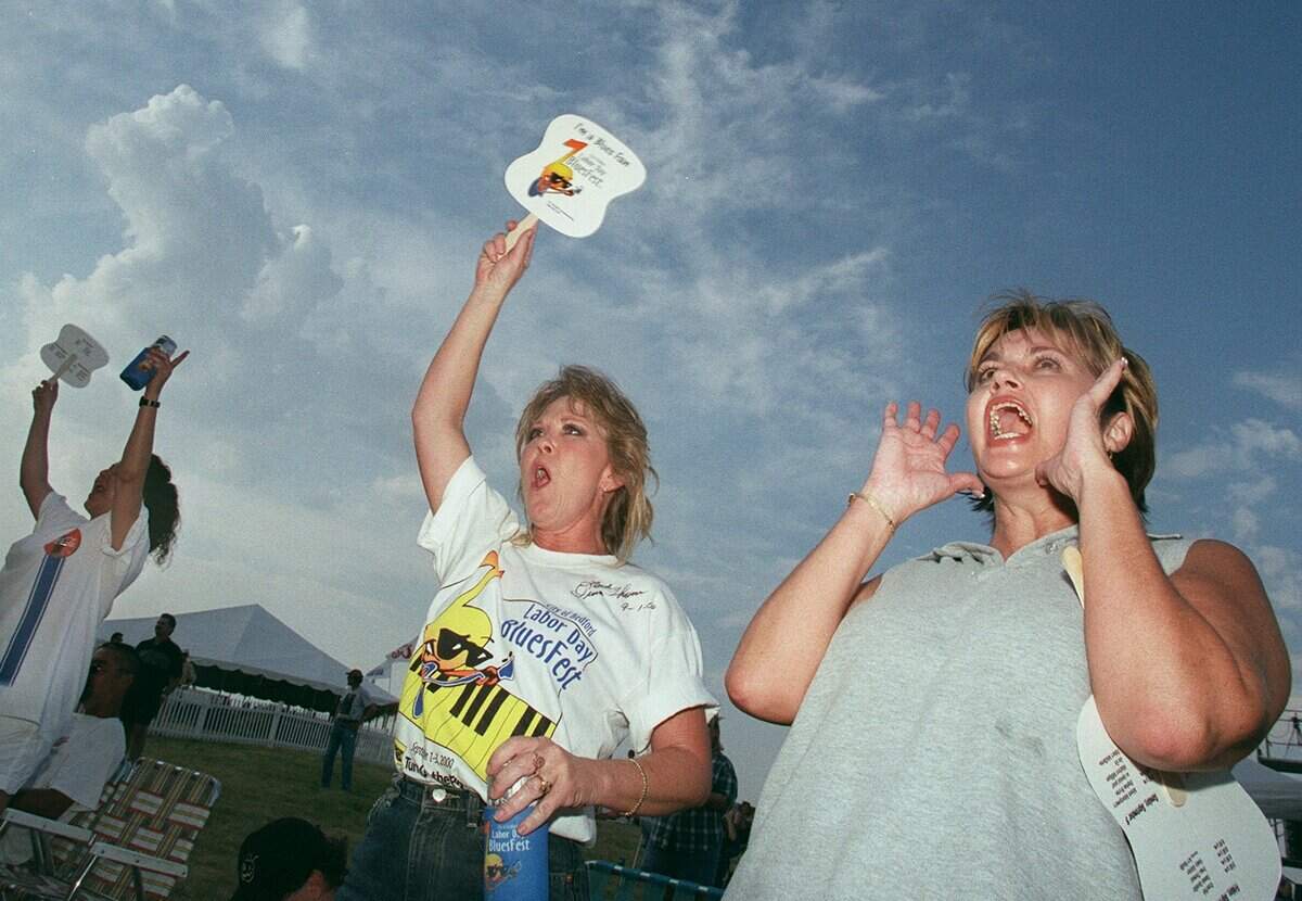 Sept. 2, 2000: Sue Lucas (right) of Euless and her friend Lindy Anderson of Grand Praire cheer for Morris Price Band at the city of Bedford Labor Day Bluesfest.