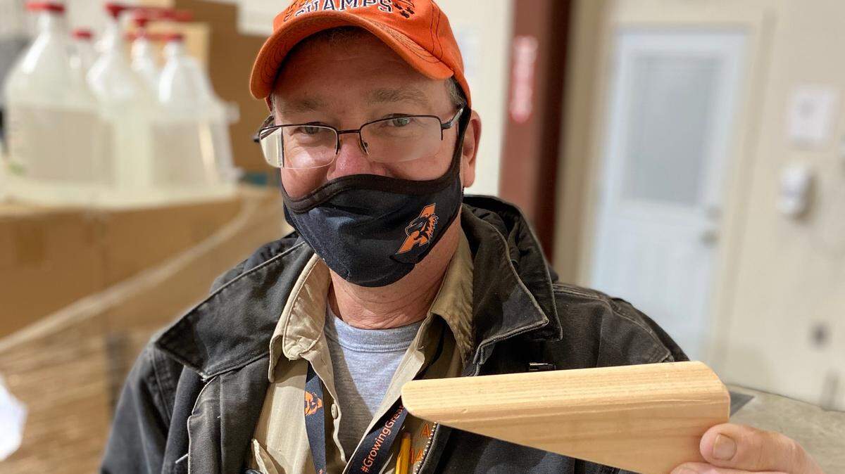 Aledo ISD maintenance worker Danny Gabbert holds up one of many doorstops he made so students and staff in the district won’t have to use their hands to open doors when going throughout the buildings. This is one of several projects, including touch-free sanitizing stations from the student engineering department, designed to help make school safer during the COVID-19 pandemic.