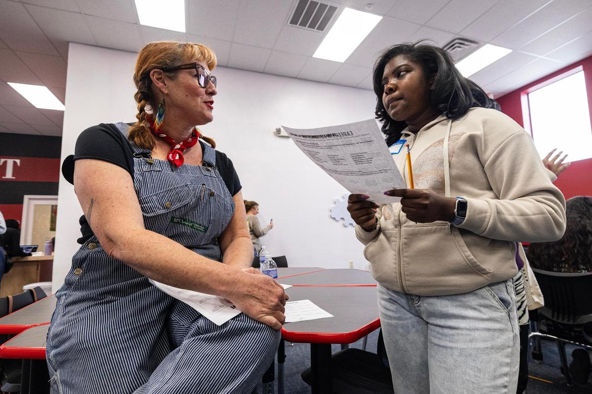 Kristin Cline, also known as Grease Girl (left) interacts with event attendees during the ‘Women in Construction’ event by Girls Inc. of Tarrant County at their headquarters in Fort Worth on Saturday, March 8, 2025.