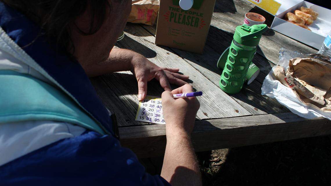 John Turner plays a round of bingo at a recent gathering of the TCU student outreach group, “Bingo in the Park.”