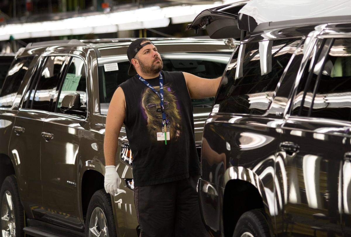 July 14, 2015: GM employee Efren Martin II checks vehicles for flaws in the final line at GM Arlington Assembly. The automaker announced $1.4 billion to improve the productivity of the plant.