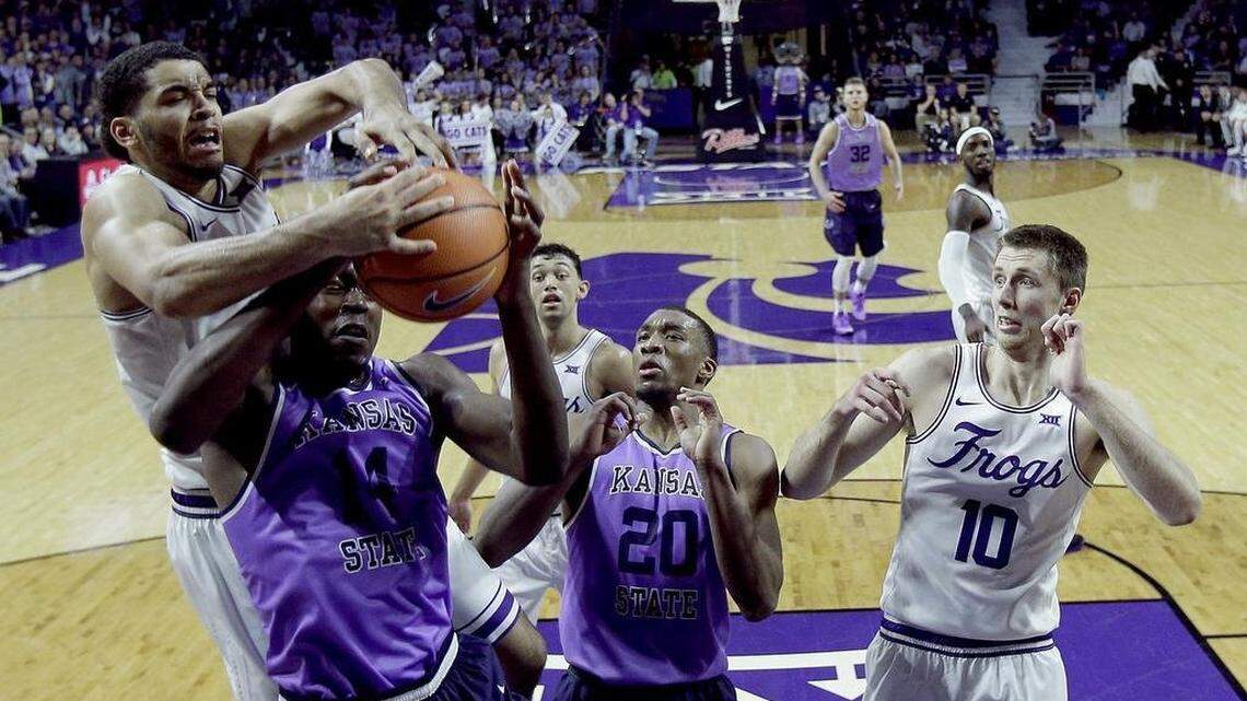TCU's Kenrich Williams battles Kansas State's Makol Mawien for a rebound during a game in Manhattan, Kan., on Jan. 20.