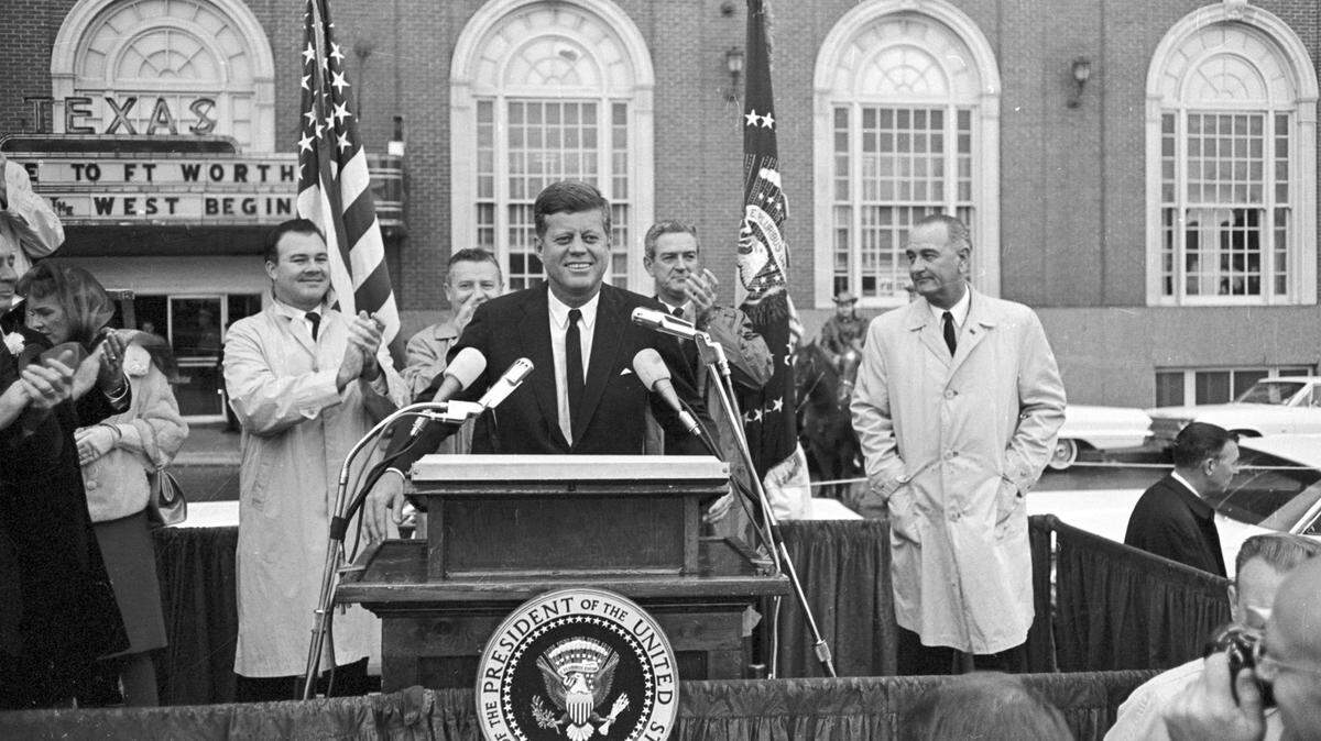 John F. Kennedy speaking to crowd in front of the Hotel Texas in Fort Worth on the morning of Nov. 22, 1963. V.P. Lyndon B. Johnson is to JFK’s left, and Texas Governor John Connally is over JFK’s left shoulder. Senator Ralph Yarborough over the president’s right shoulder, and State Senator Don Kennard stands to JFK’s right.