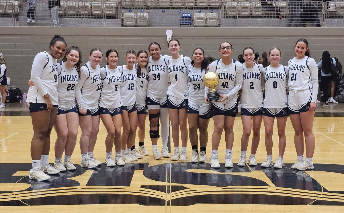 The Keller girls basketball team poses with some hardware after defeating Mansfield Lake Ridge 42-39 in a Class 6A Division I bi-district game on Tuesday, February 17, 2026 at Thomas Coliseum in Haltom City, Texas.