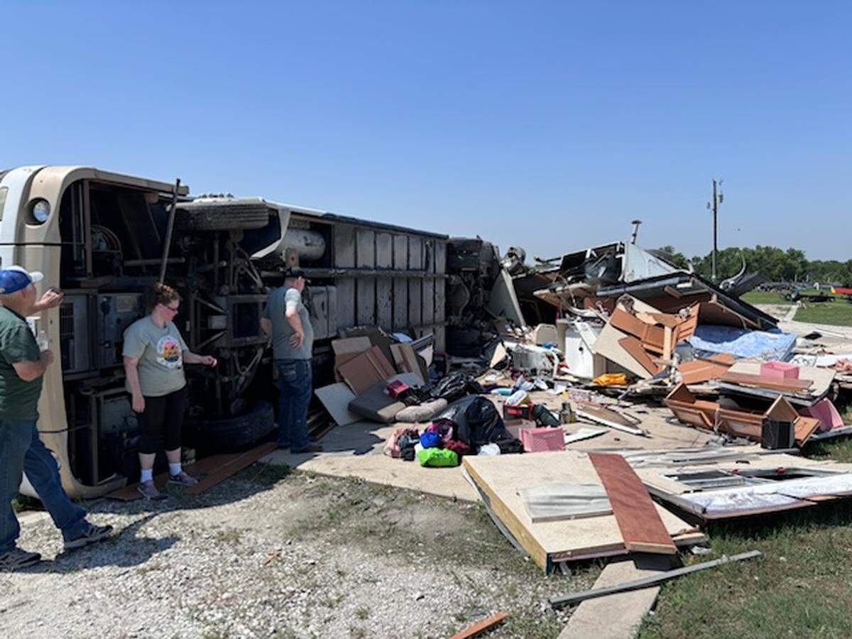 Amber Bryant stands near her RV on Sunday, May 26, 2024, after it was flipped during severe storms that moved through the area on Saturday night.