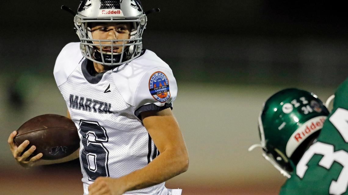 Martin quarterback Zach Mundell (6) attempts to avoid the tackle of Arlington linebacker EJ Higgins during the first half of Friday’s game at UTA Maverick Stadium in Arlington, Texas, Oct. 18, 2019.