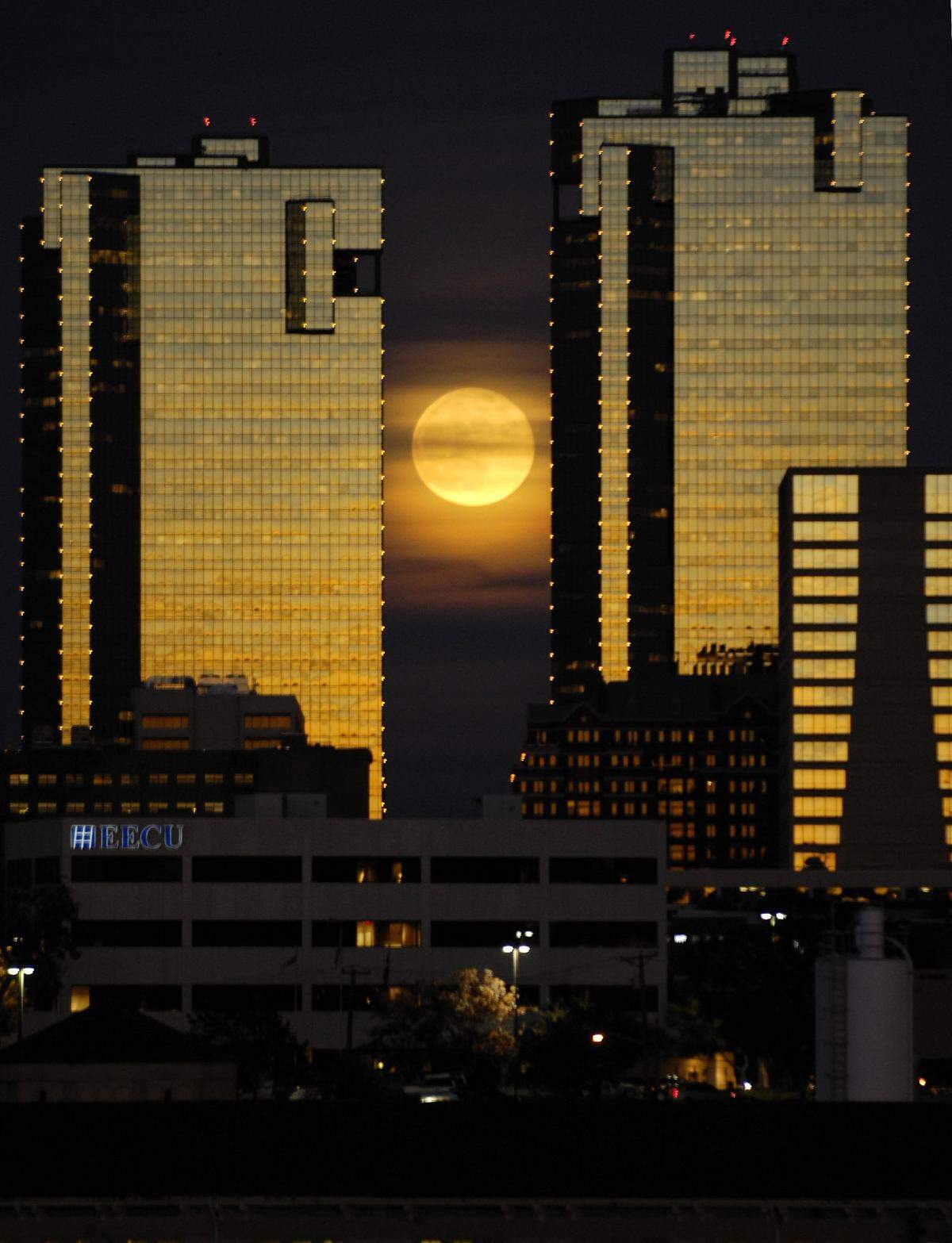 A full moon rises between the two City Center towers in downtown Fort Worth on Dec. 12, 2008.