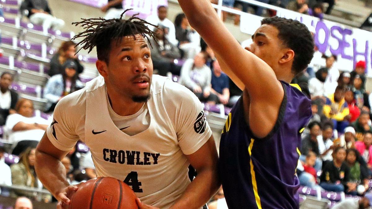 Crowley wing Hayden Brittingham gets fouled by Everman post Derek Williams in the paint in the second quarter of a high school basketball game at Crowley High School in Crowley, Texas, Friday, Jan. 31, 2020. Everman led 27-19 at the half. (Special to the Star-Telegram Bob Booth)